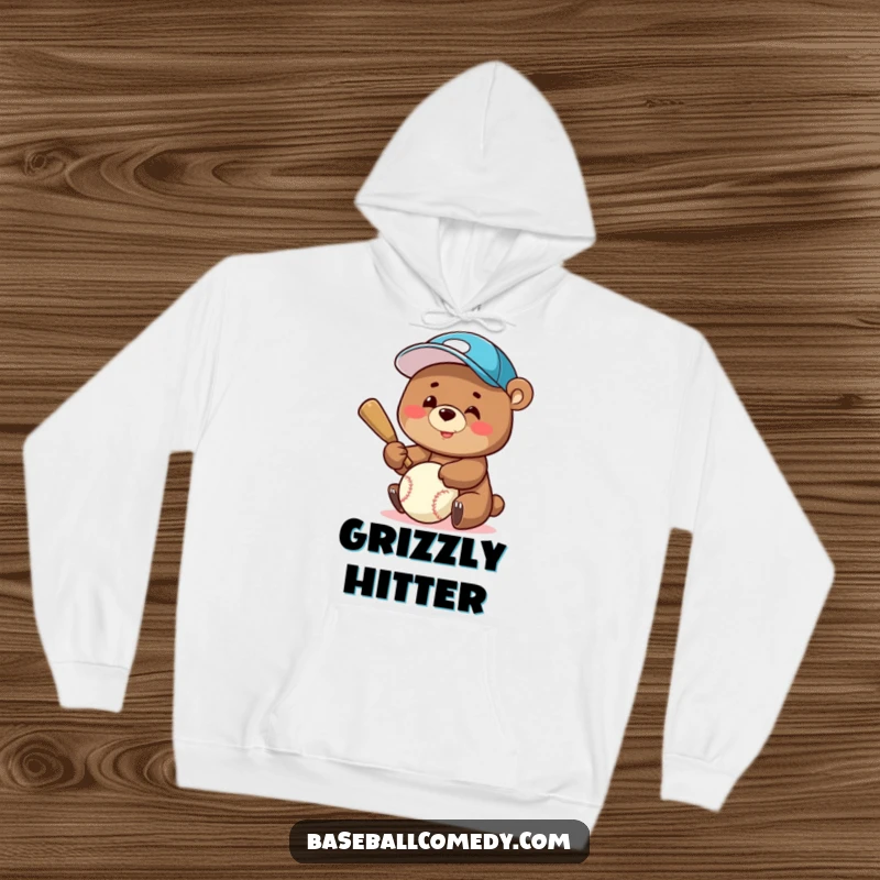Funny Hoodie: A happy bear in a baseball cap is pictured batting a baseball, radiating joy and sports enthusiasm.