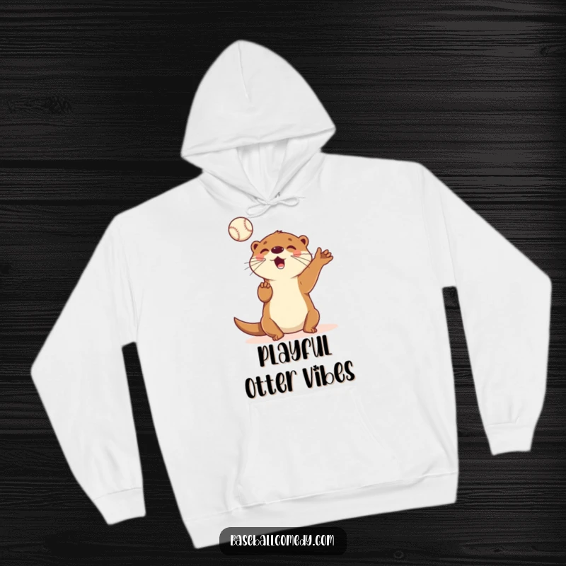 Funny hoodie featuring a cartoon otter skillfully juggling baseballs in the air with a gleeful, playful expression, radiating fun.