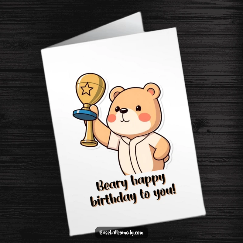 Funny Free Printable Birthday Card: A proud bear holding a baseball trophy high, celebrating a birthday victory.