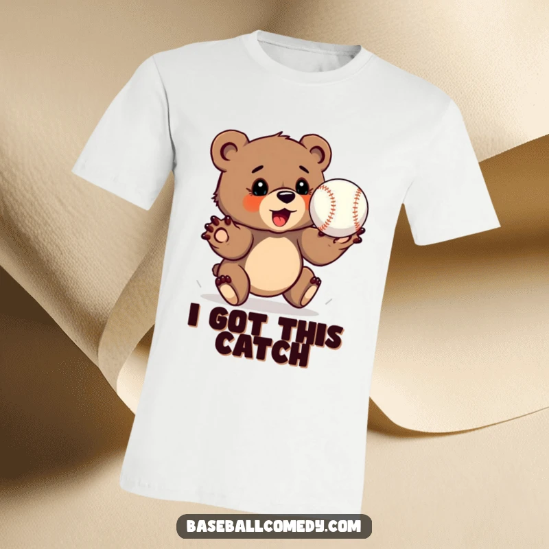 Funny bear cub t-shirt, determinedly catching a baseball with outstretched paws, ready for action.